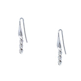 A closeup of silver chain earrings designed and hand-crafted by DelBrenna Italian Jewelers in Tuscany. The earrings are designed based on the iconic Links collection of DelBrenna silver chains, necklaces, rings, and bracelets.